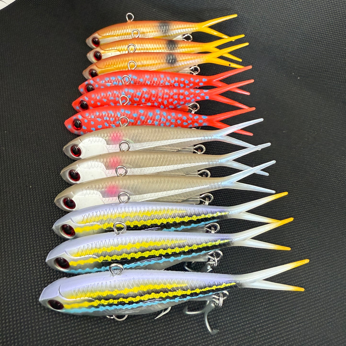 Assorted 115mm and 95mm Tough Vibe fishing lures with strong trebles and split rings for reef, barra, and jack fishing – Reel Action Lures
