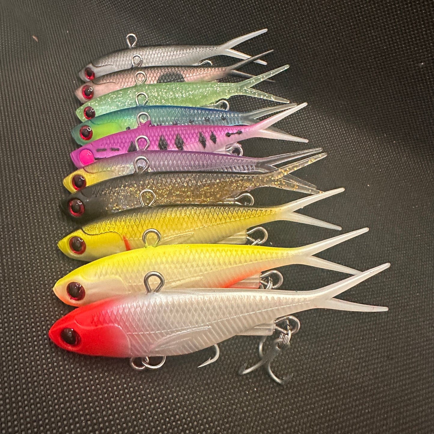 Close-up of 95mm 20g lipless vibes with HD split rings and strong trebles, designed for estuary, creek, and reef fishing – Reel Action Lure