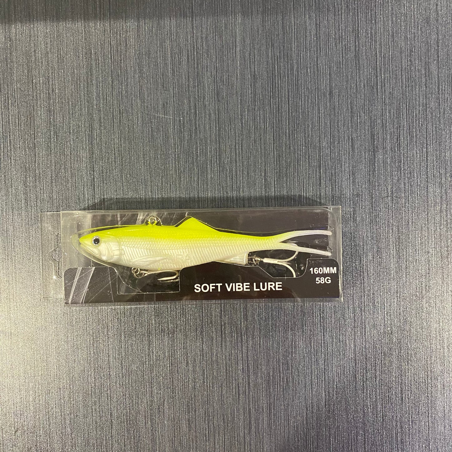 Side profile of packaged 160mm Chartreuse/White Reel Action Vibe lure, ready for reef and offshore fishing.