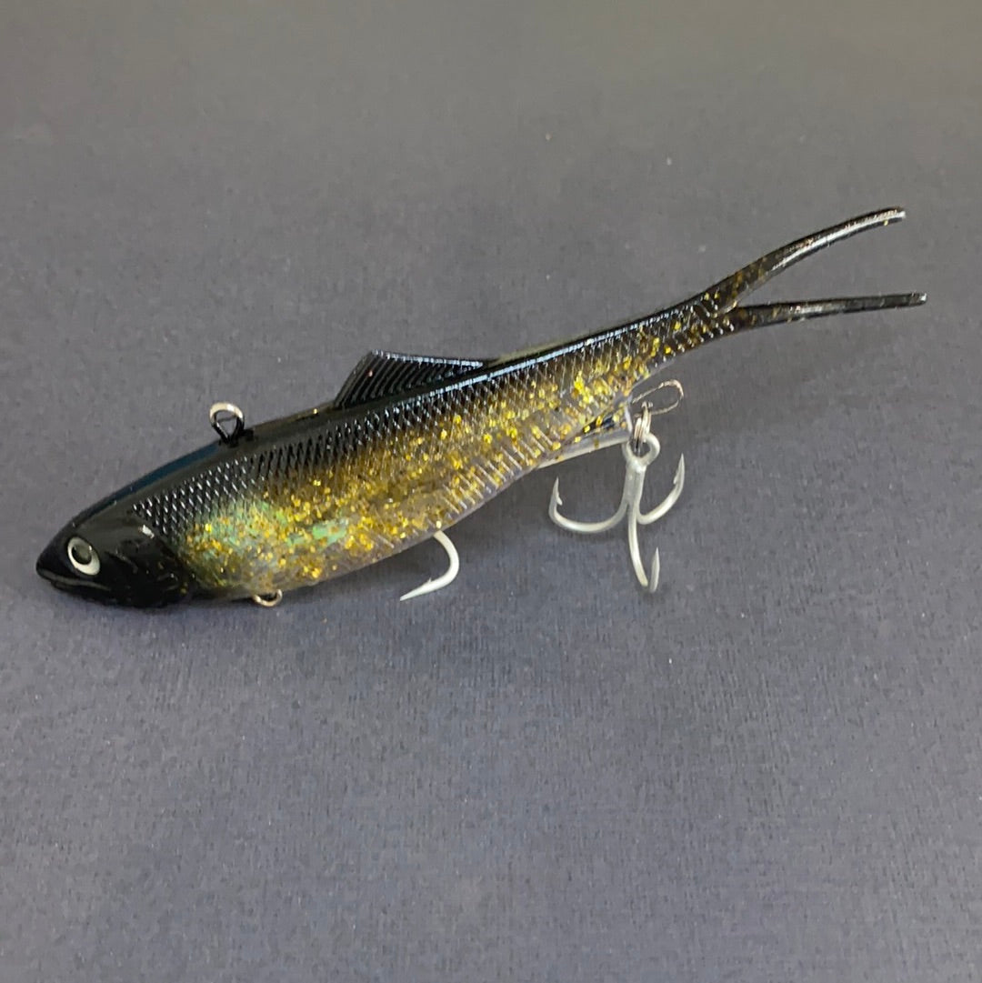 Close-up of Reel Action 160mm Black & Gold Vibe fishing lure with soft plastic tail and BKK trebles.