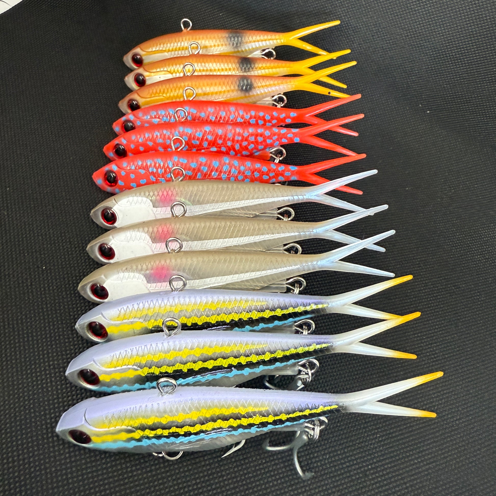 Assorted 115mm and 95mm Tough Vibe fishing lures with strong trebles and split rings for reef, barra, and jack fishing – Reel Action Lures